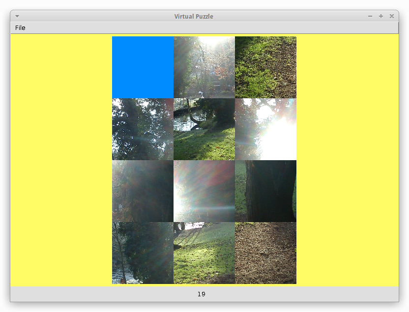 Virtual puzzle screenshot showing a photograph of a park in 3x4 tiled pieces jumbled up on a yellow background in an application window. One of the pieces is a blank blue space.