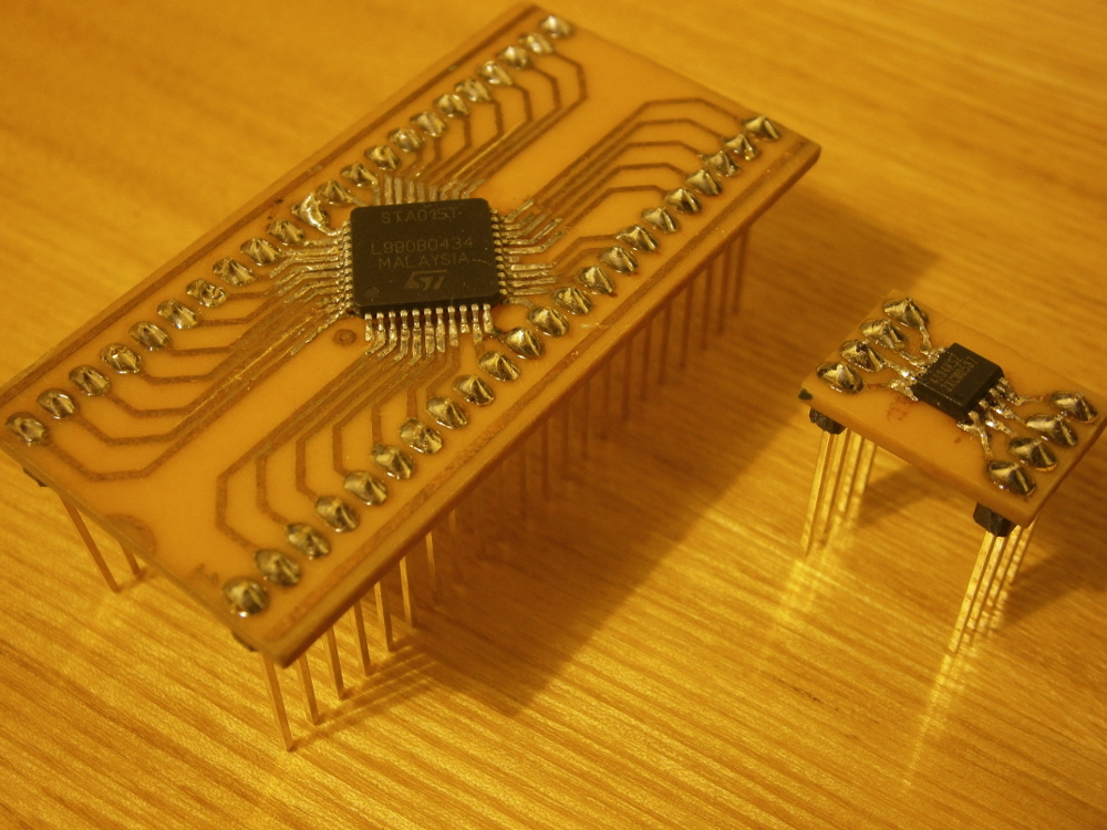 Photo of home made PCBs with QFP and SO-8 chips soldered to them